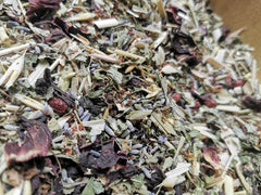 Inner Alchemy tin with herbs and flowers – calming adaptogenic herbal tea blend