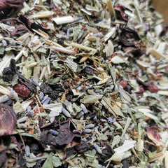 Inner Alchemy tin with herbs and flowers – calming adaptogenic herbal tea blend
