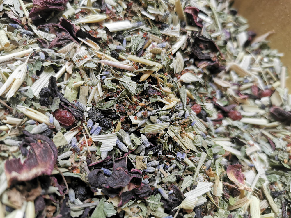 Inner Alchemy tin with herbs and flowers – calming adaptogenic herbal tea blend